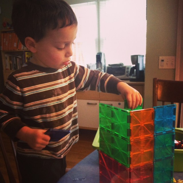 My two-year-old son building with Magna-Tiles