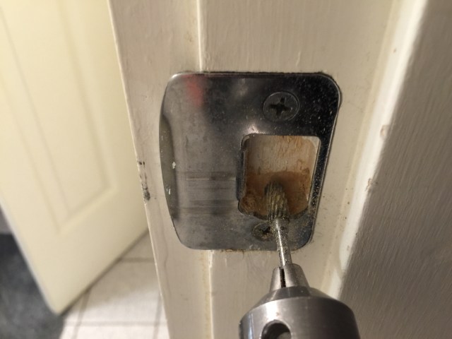 By attaching the burrs to my drill, I was able to quickly grind down the bottom of the hole on the strike plate to make it bigger.